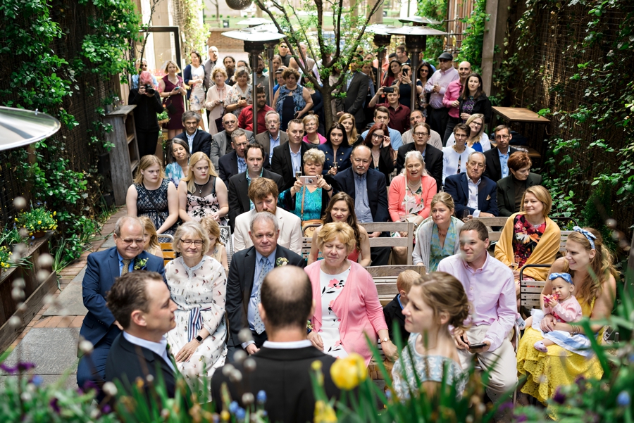 A couple saying their vows in front of their friends and family at Talula's Garden in Philadelphia.